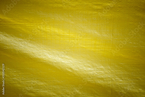 Yellow vinyl fabric texture that can be used as a background