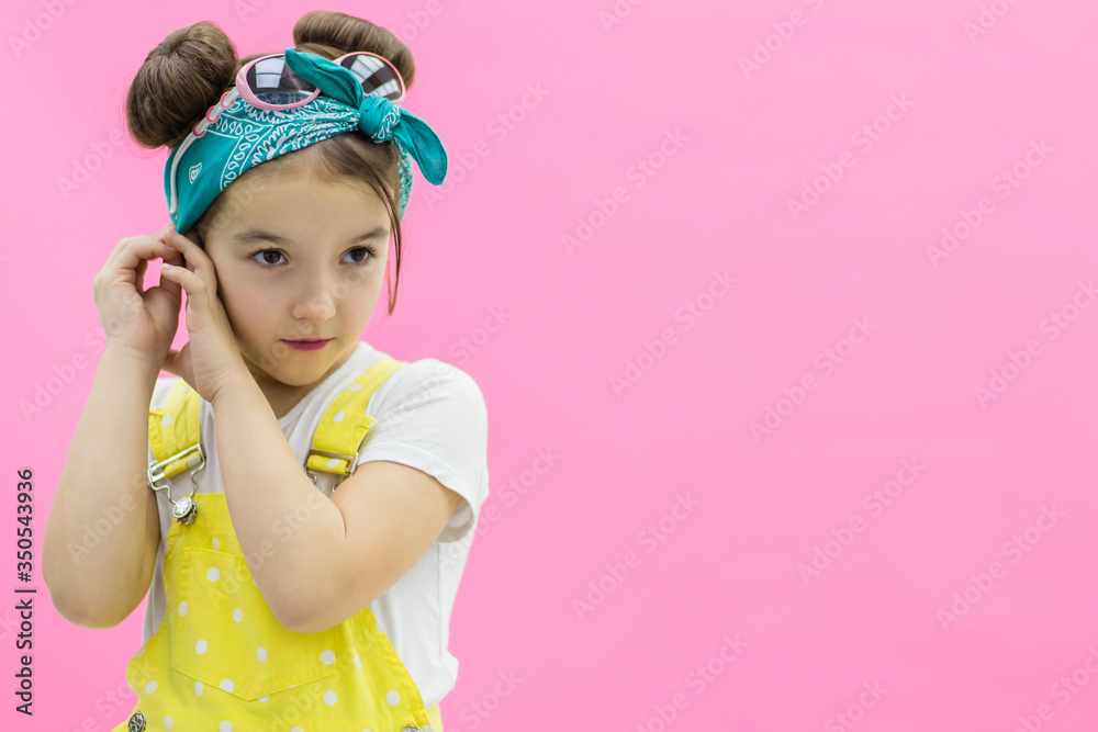View of a girl wearing jumpsuit in polka-dot looking straight. View of a girl wearing jumpsuit in polka-dot looking straight.