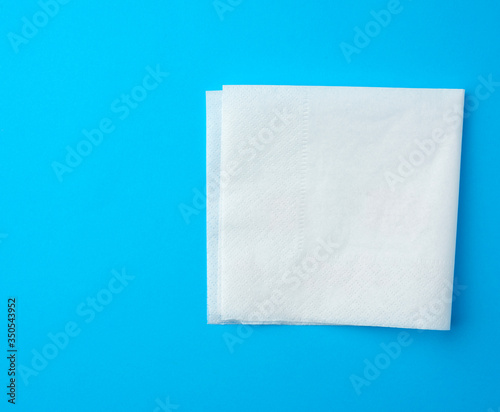 white paper napkins on a blue background, place for inscription