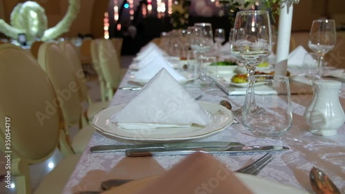 Elegantly made empty dinner tables in a chic restaurant shot with a slider.