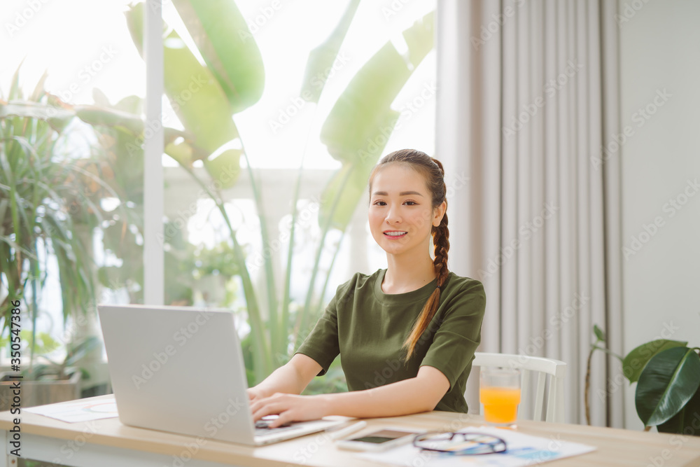 Happy Young Beautiful Woman Using Laptop, Indoors Happy Young Beautiful Woman Using Laptop, Indoors