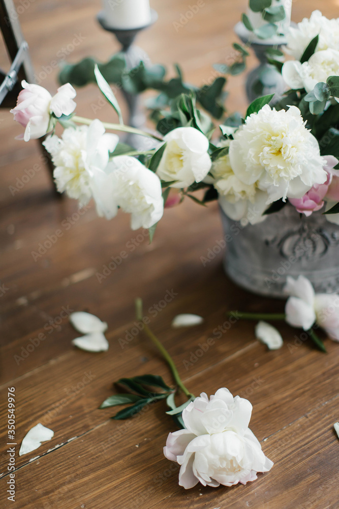 Composition of white and pink peonies. White peony petals on the floor. Interior decoration with flowers. flower composition Composition of white and pink peonies. White peony petals on the floor. Interior decoration with flowers. flower composition