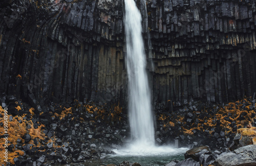 waterfall and black rocks