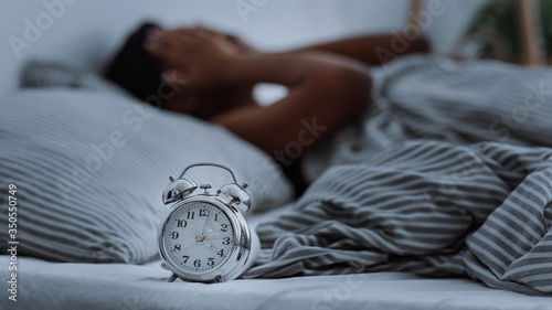 Canvas Print African american woman suffering from insomnia lying in bed without sleep