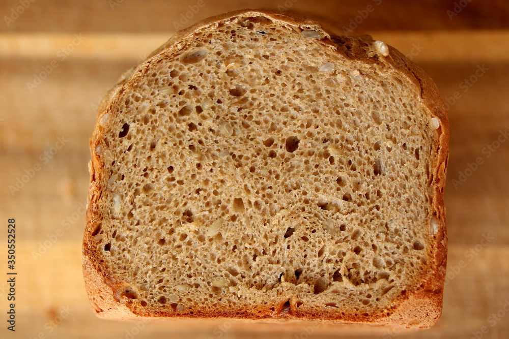 beautiful slice of a freshly baked loaf of homemade bread with a brown crust close-up, the concept of home-made cuisine, organic food, healthy eating beautiful slice of a freshly baked loaf of homemade bread with a brown crust close-up, the concept of home-made cuisine, organic food, healthy eating