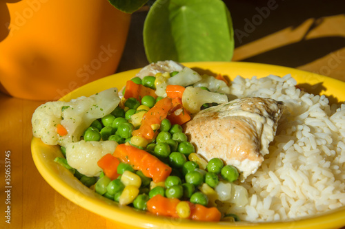 Close Up of a colorful healthy dinner with fish, rice and vegetables
