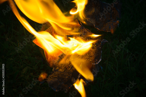 Close Up of a burning picture on grass
