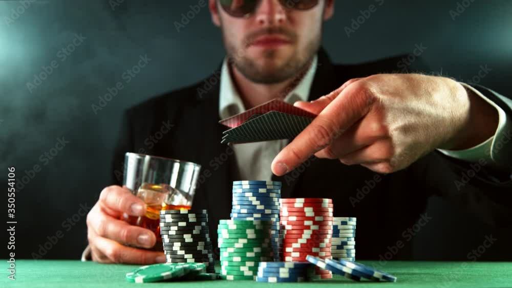 Super slow motion of poker player throwing cards towards camera. Filmed on high speed cinema camera, 1000fps. Super slow motion of poker player throwing cards towards camera. Filmed on high speed cinema camera, 1000fps.
