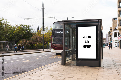 Fototapeta Naklejka Na Ścianę i Meble -  Empty advertising light box. Billboard on a bus stop. Your ad. Bus in background