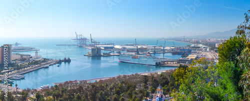 Breathtaking aerial panoramic view from Mount Gibralfaro of big old city, harbor, port, docks and seafront. Costa del Sol. Malaga. Andalusia. Spain.