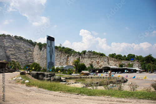 Big buddha carving on stone cliff of Wat Khao Tham Thiam for thai people travel visit and respect pray at U Thong city on October 28, 2019 in Suphanburi, Thailand photo