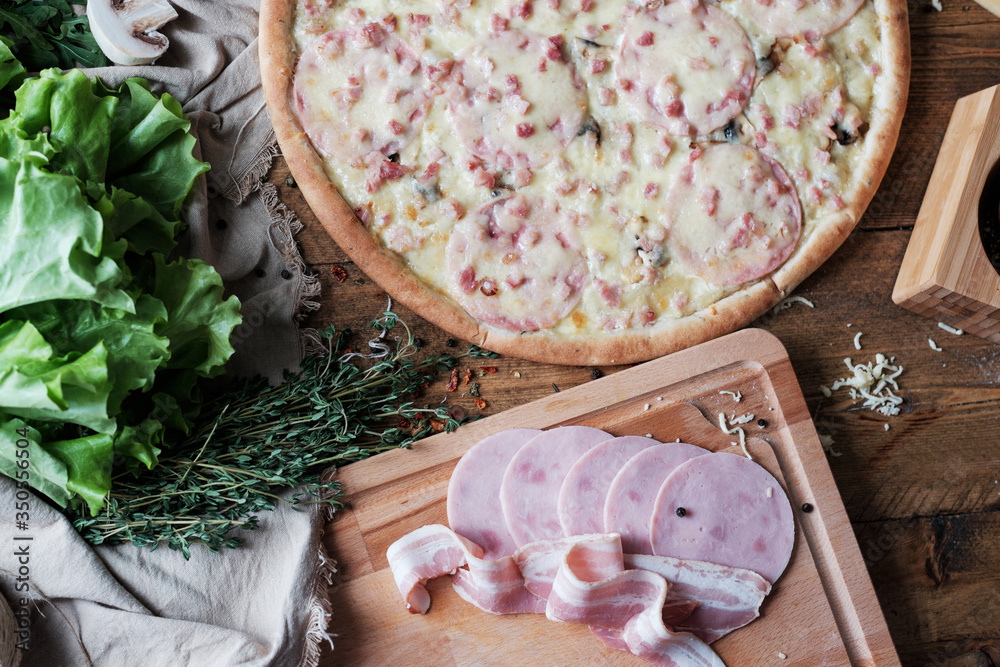 pizza with meat and ingredient on the wooden table in rustik style pizza with meat and ingredient on the wooden table in rustik style