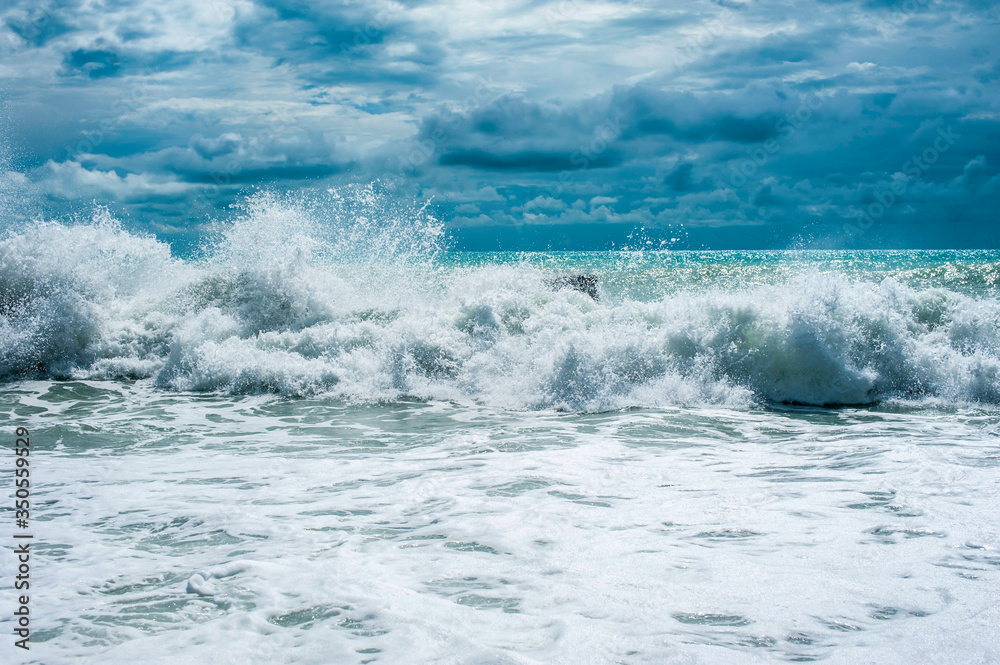 Storm waves on the ocean against a turquoise sky and clouds. Surf Storm waves on the ocean against a turquoise sky and clouds. Surf