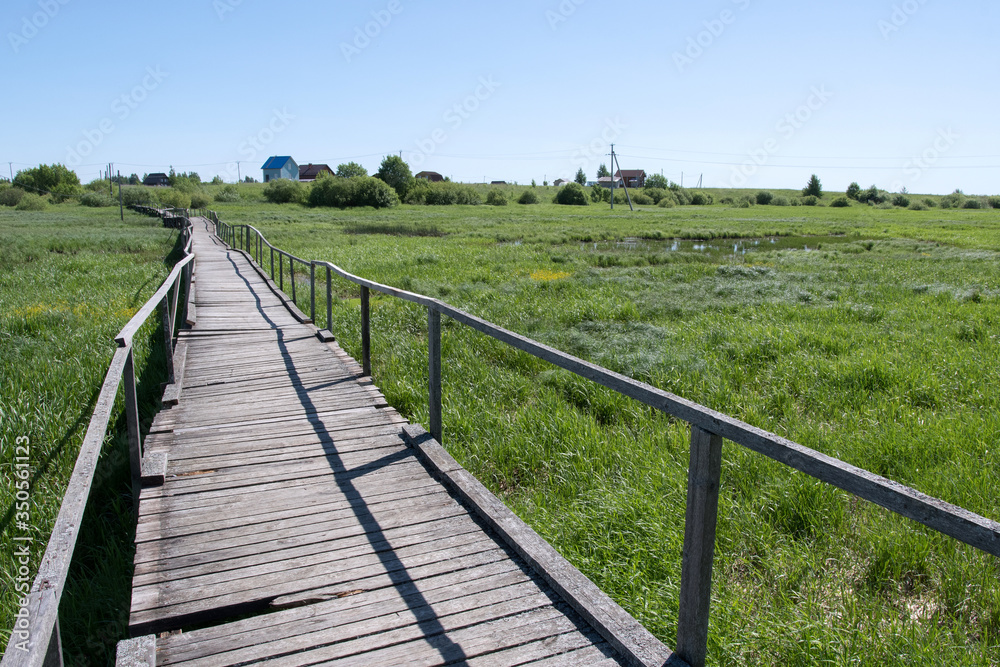 Wooden pathway over a swampy area between Staroye Rakomo and Novoye Rakomo villages (Lake Ilmen region), Novgorod Oblast, Russia.