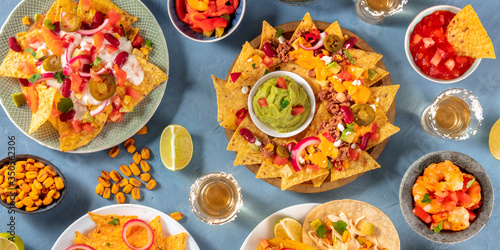 Mexican food panorama, shot from the top. Nachos, guacamole, tequila, tacos and other dishes, a flat lay