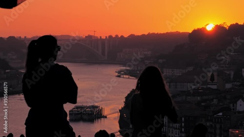Dancing people mother and daughter enjoying the sunset on the Douro river