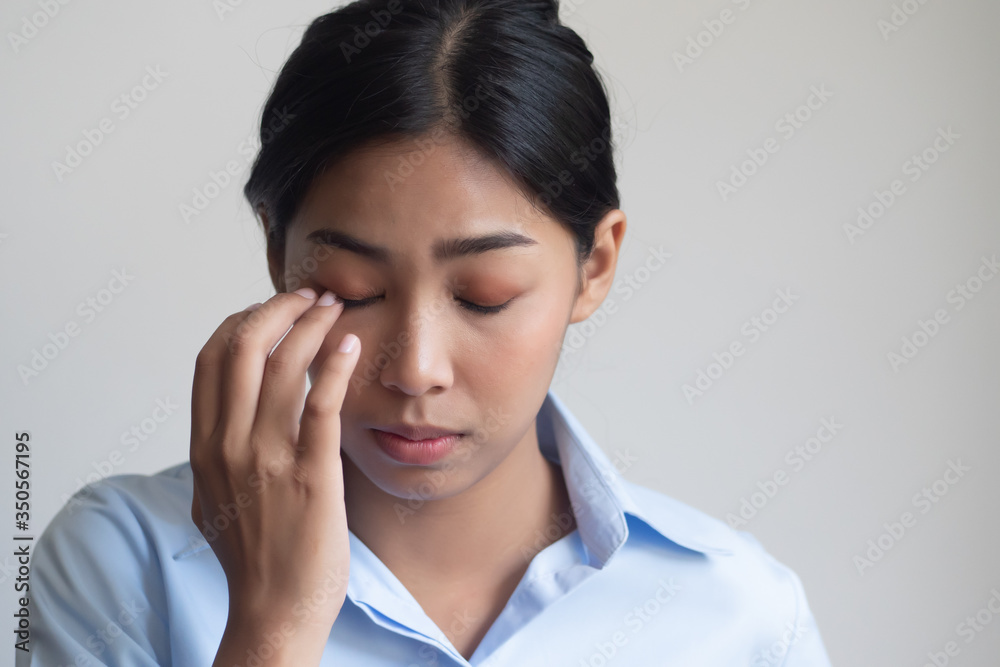 asian woman suffering from irritated eye; concept of optical health care, red eye allergy, eye care, allergic or itching or dry eye inflammation; young adult asian woman model asian woman suffering from irritated eye; concept of optical health care, red eye allergy, eye care, allergic or itching or dry eye inflammation; young adult asian woman model