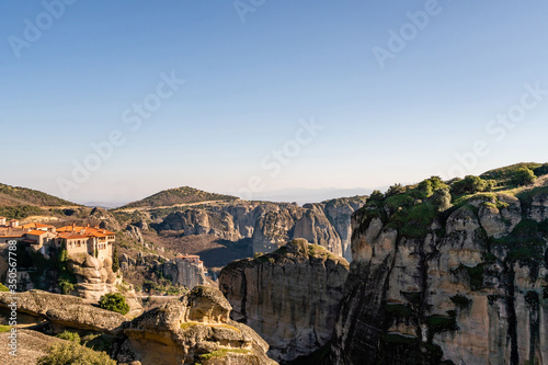 Orthodox monastery on rock formations against blue sky in meteora