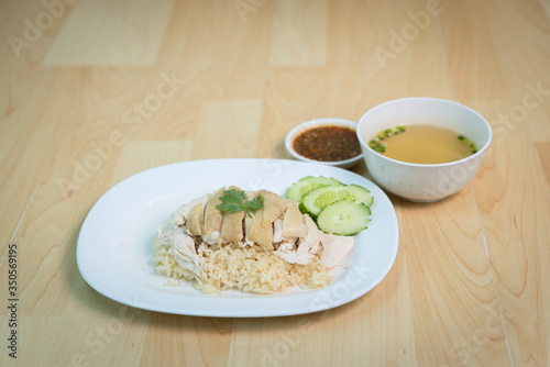 Steam Chicken with Rice (Hainan Chicken) on wooden table