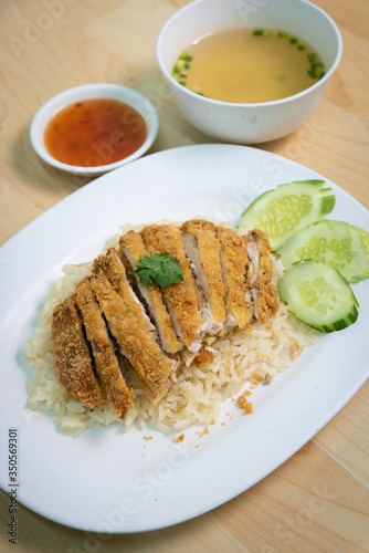 Fried chicken with rice. Thai Style Hainan Chicken. on The wood table.