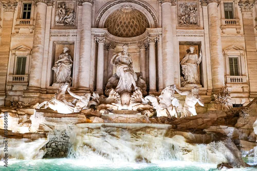 Trevi Fountain with ancient sculptures near water in rome