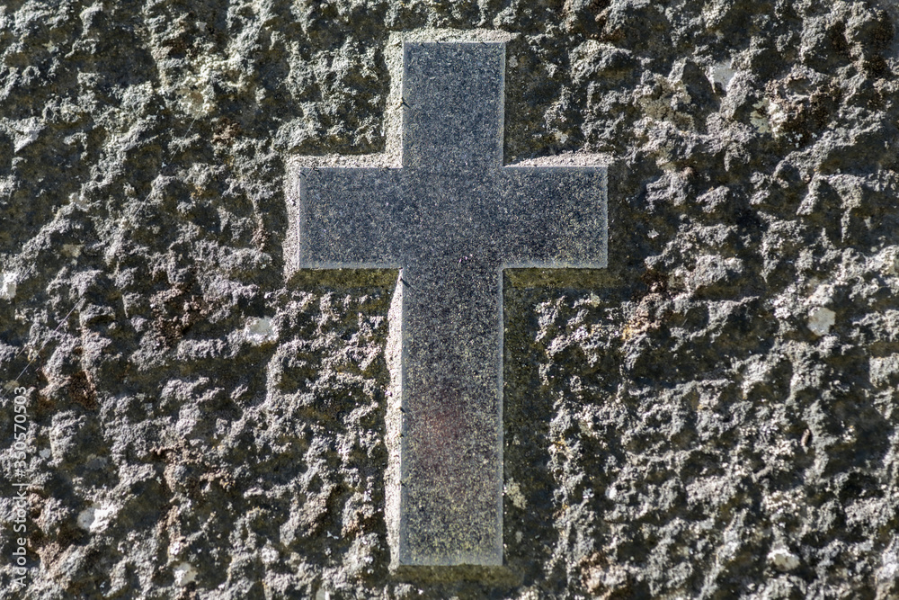 Cross symbol chiseled on a gravestone