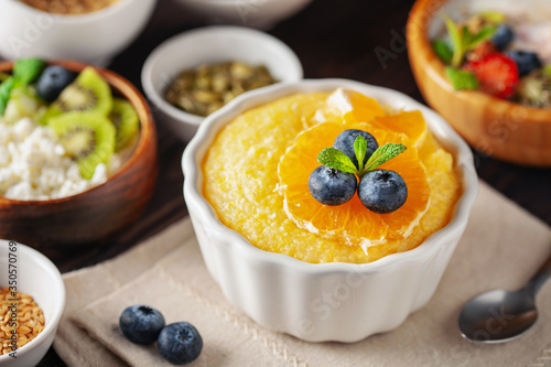 Healthy breakfast set with corn porridge  yogurt  berries  coffee and granola.