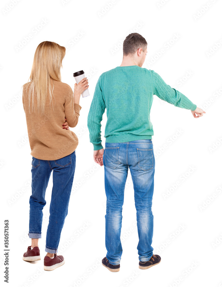 Back view of couple in sweater pointing. Back view of couple in sweater pointing.