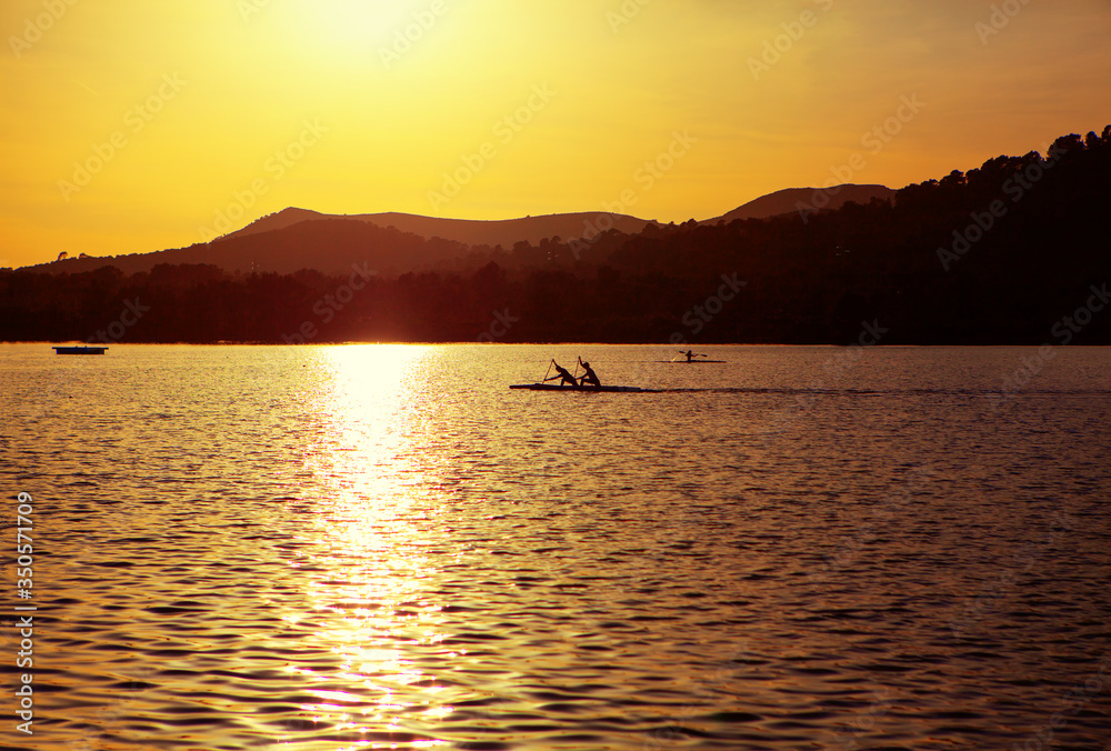 kayak in the sunlight , scenery with lake and mountains in the twilight 