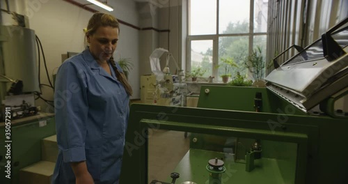 Slipless wire drawing machines, capstans. female worker at metal production plant, 4k photo