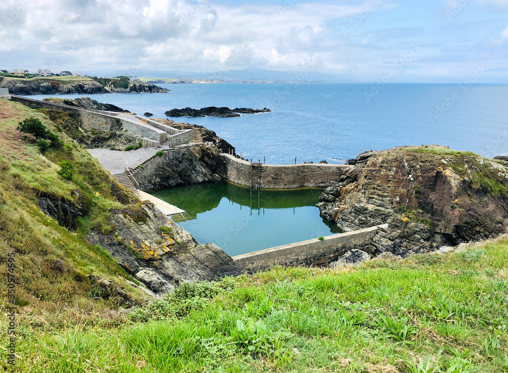 View of the natural public swimming pool near the seaport in Tapia de Casariego, Asturias - Spain