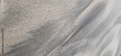 Black sand texture found on the coast of southeastern Brazil.
