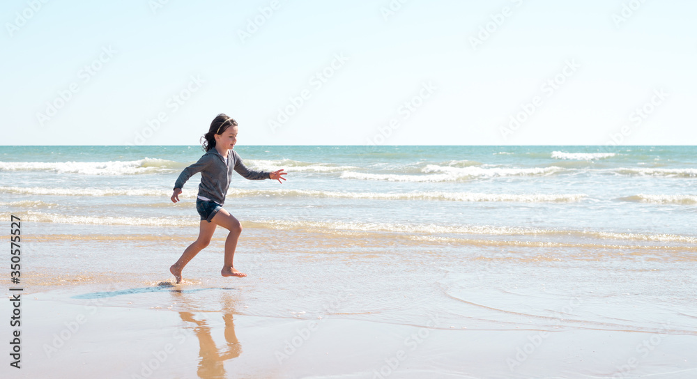 Young girl enjoying the beach on a beautiful sunny day