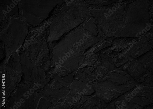 Black stone textured wall. Grunge background