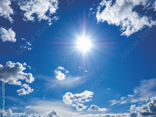 Blue sky with sun and white clouds. Nature landscape on sunny day. Clearing day and good weather