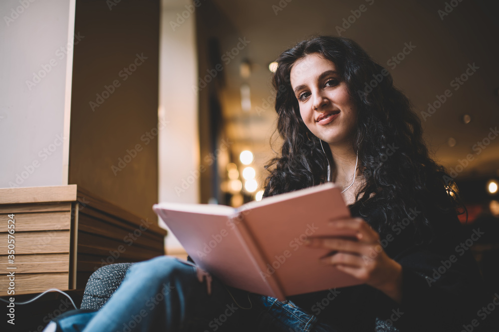 Young woman reading book in library Young woman reading book in library
