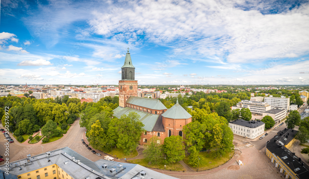 Aerial panorama view of an old cathedral next to a city in Turku, Finland at summer.