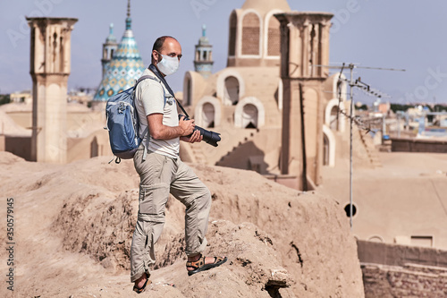 Traveler with surgical mask in Kashan old city.