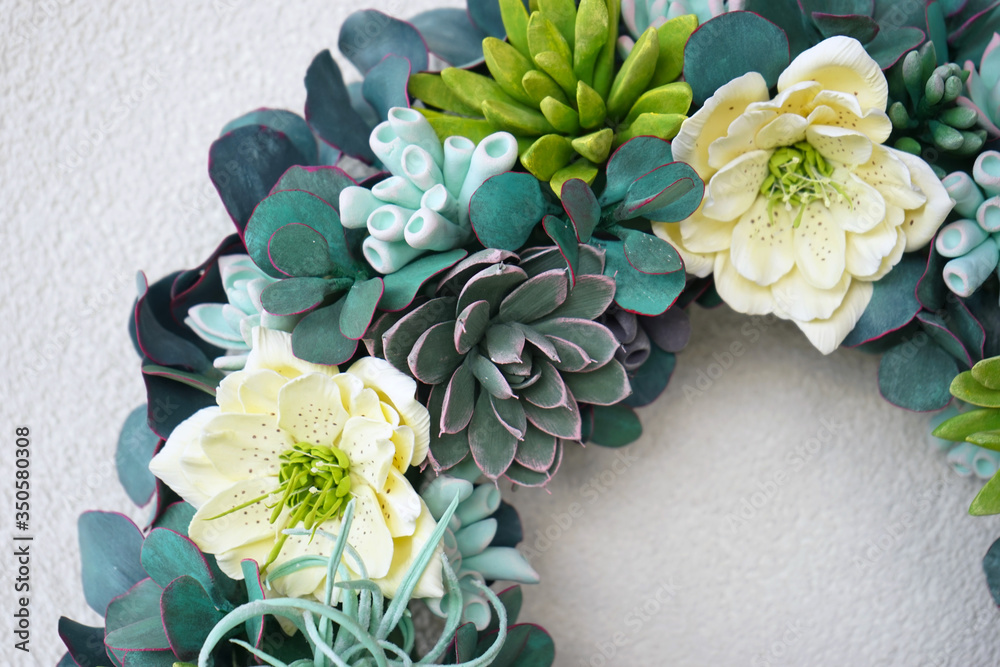 A beautiful flower wreath made of succulents on a white background A beautiful flower wreath made of succulents on a white background
