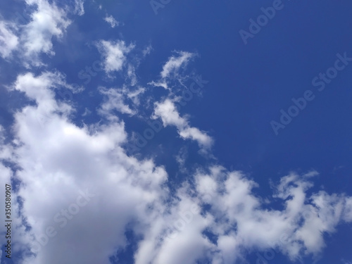 White clouds on blue sky background with copy space