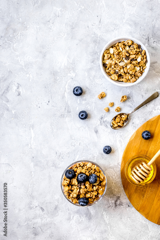 Oat flakes and berries granola glass on table background top view