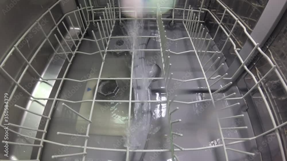 The master repairs the dishwasher and checks the operation of the