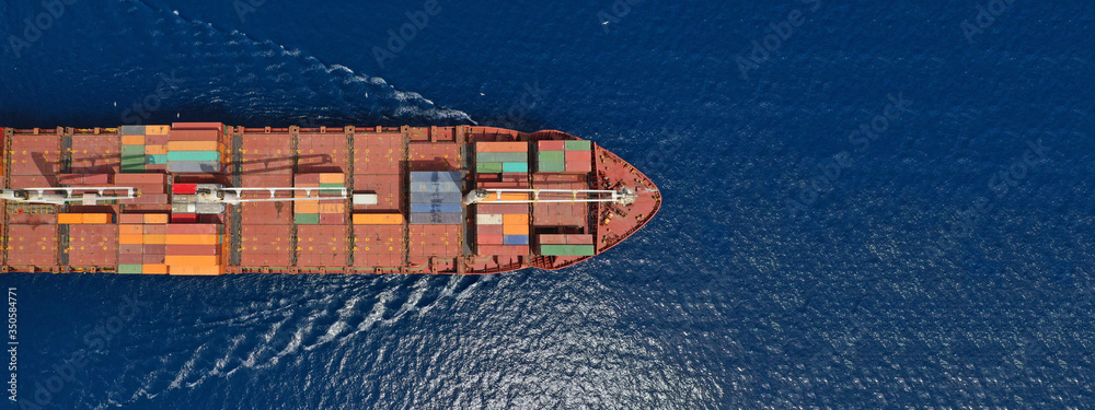 Fototapeta premium Aerial drone panoramic photo of industrial container tanker cruising in open ocean deep blue sea 