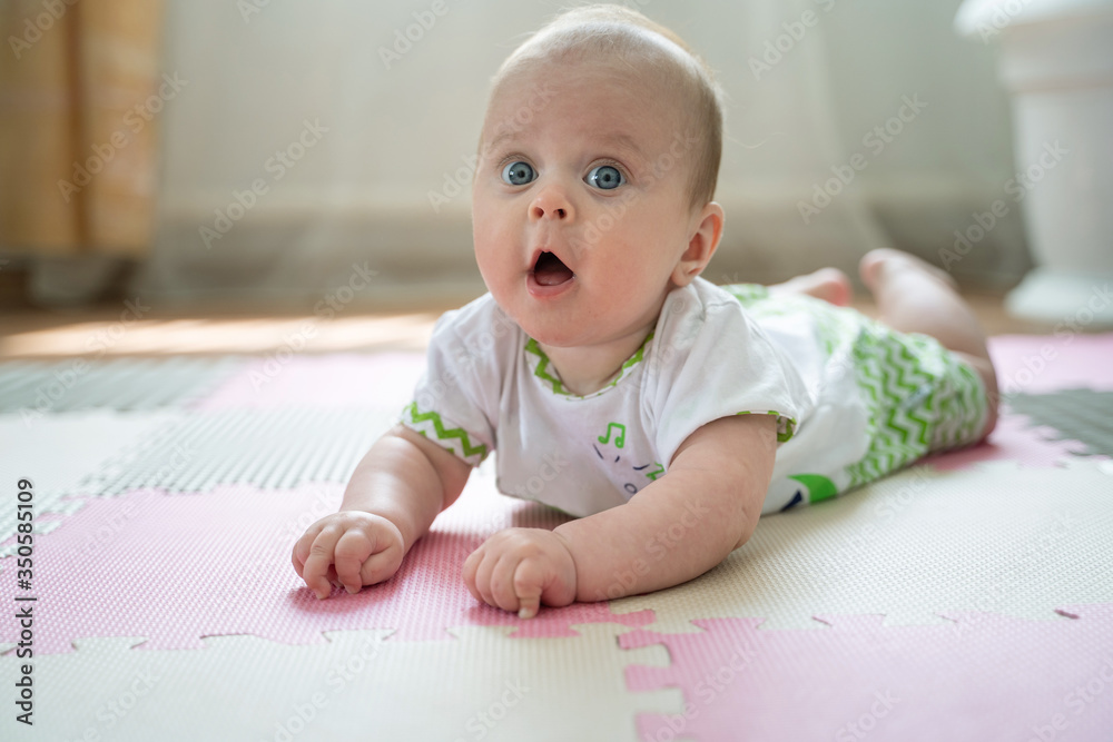 The baby is on the floor The baby is on the floor