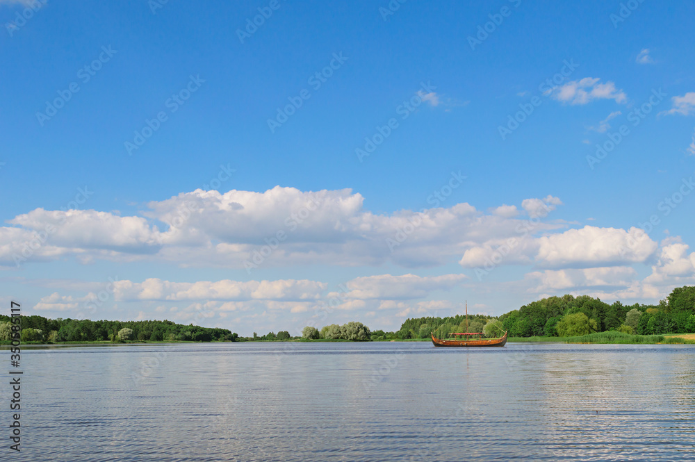 Panoramic view with beautiful blue sky and clouds on the lake near Nesvizh castle. Postcard concept