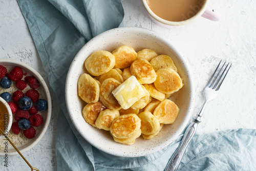 Fototapeta Naklejka Na Ścianę i Meble -  Pancakes cereal, tiny thin funny crumpet, children's food. Breakfast with drink
