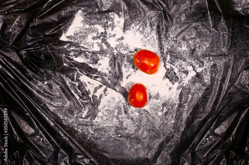 Red colour tomato in creative dark background
