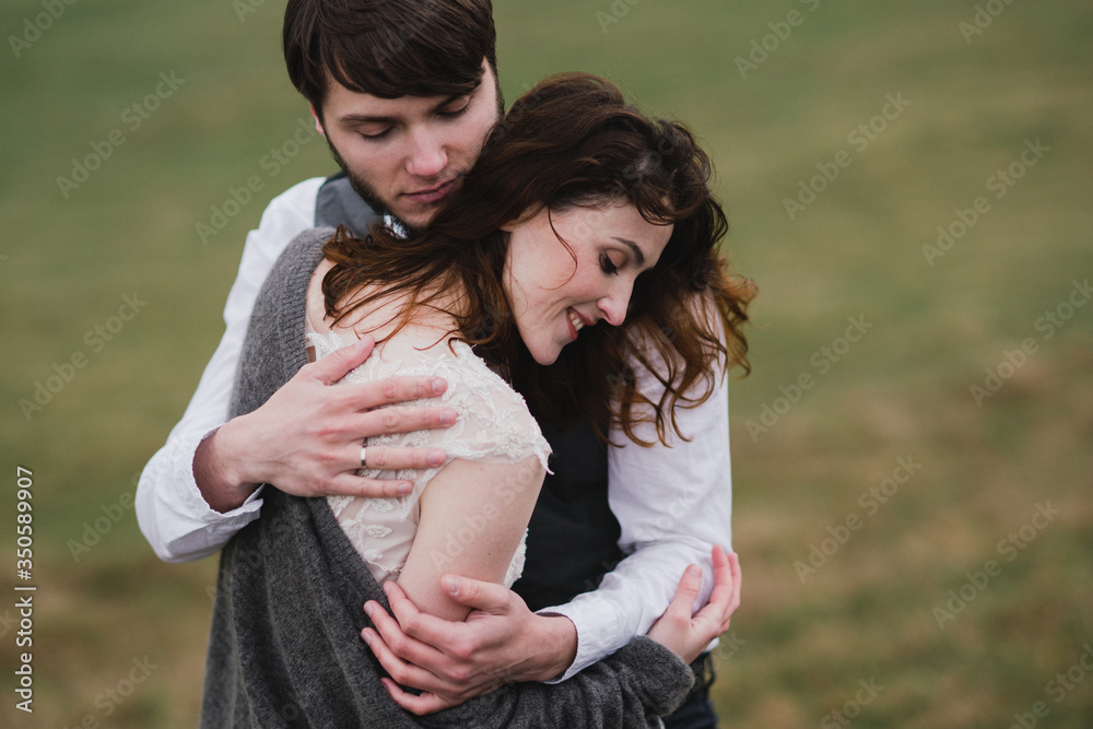 Romantic, young and happy caucasian couple in wedding clothes hugging on the background of beautiful mountains. Love, relationships, romance, happiness concept. Bride and groom traveling together. Romantic, young and happy caucasian couple in wedding clothes hugging on the background of beautiful mountains. Love, relationships, romance, happiness concept. Bride and groom traveling together.