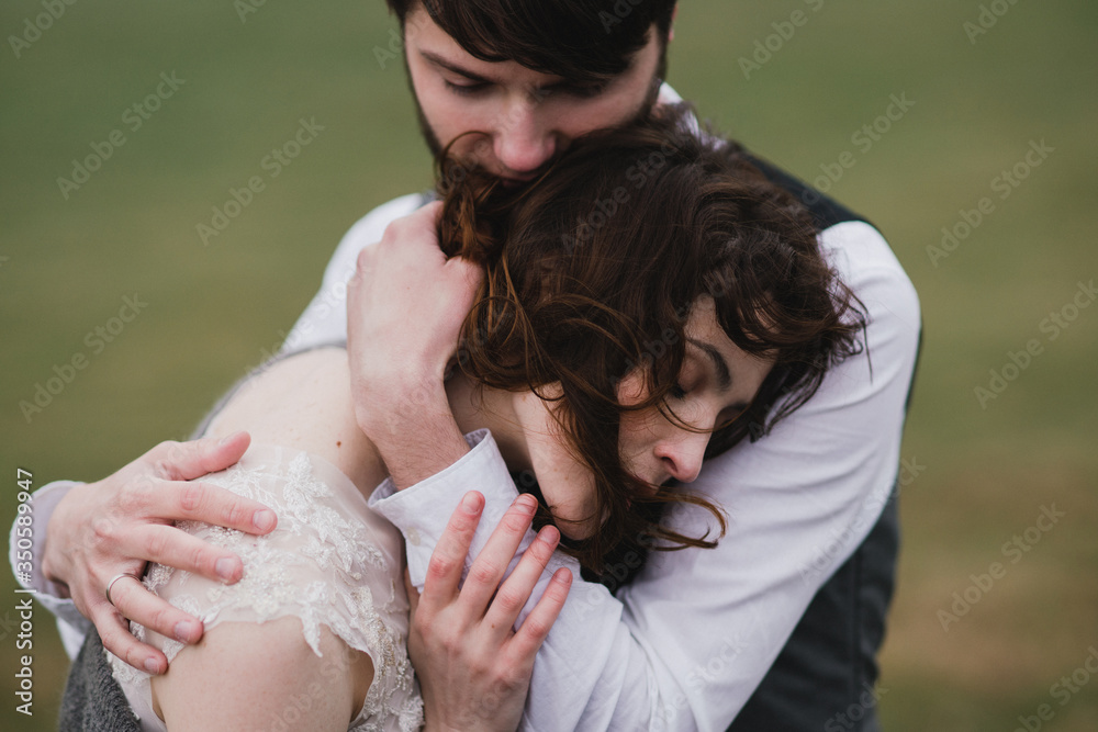 Romantic, young and happy caucasian couple in wedding clothes hugging on the background of beautiful mountains. Love, relationships, romance, happiness concept. Bride and groom traveling together. Romantic, young and happy caucasian couple in wedding clothes hugging on the background of beautiful mountains. Love, relationships, romance, happiness concept. Bride and groom traveling together.