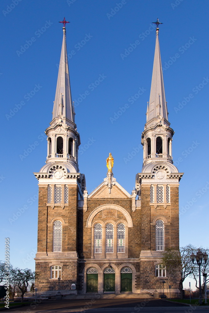 Vertical frontal view of the monumental Notre-Dame-de-l’Annonciation church in L’Ancienne-Lorette, small town in the vicinity of Quebec City, Quebec, Canada